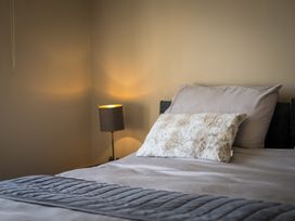 A bedroom with a bed and lamp at Souterstead in Torver near Coniston