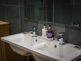 A bathroom with a double sink and soap dispensers at Souterstead in Torver near Coniston