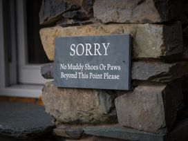 A sign indicating no muddy shoes or paws beyond this point at Souterstead, Torver near Coniston