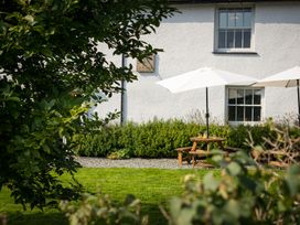 A garden with picnic table and umbrellas at Souterstead in Torver near Coniston