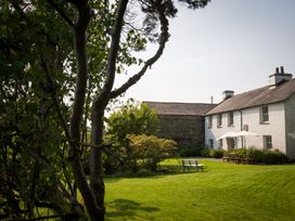 A house and garden with trees and seating at Souterstead Torver near Coniston