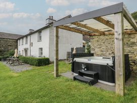 A garden with a hot tub and patio furniture at Souterstead in Torver near Coniston
