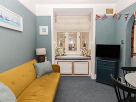 A living room with a sofa and television at Home by the Harbour Dartmouth