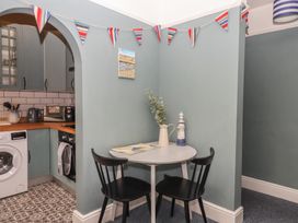 A kitchen with a table and chairs at Home by the Harbour in Dartmouth