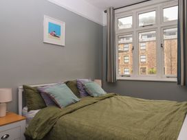 A bedroom with a bed and window at Home by the Harbour in Dartmouth