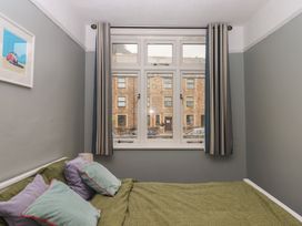 A bedroom with a bed and window at Home by the Harbour in Dartmouth