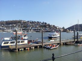 A ferry docked at a pier with boats in the water at Home by the Harbour in Dartmouth