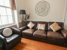 A living room with a sofa and armchair at 9 The Esplanade