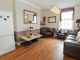 A living room with a table and chairs at 9 The Esplanade