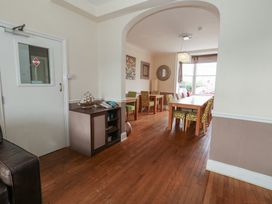 A dining room with a long table and chairs at 9 The Esplanade