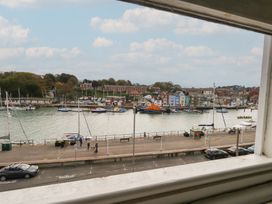 A view of a marina with boats and buildings at 9 The Esplanade in 