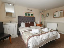 A bedroom with a bed and a desk at 9 The Esplanade