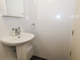 A bathroom with sink and mirror at 9 The Esplanade