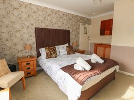 A bedroom with a bed and furniture at 9 The Esplanade