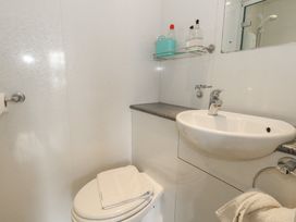 A bathroom with a toilet and sink at 9 The Esplanade