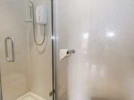 A shower area with a shower head and control panel at 9 The Esplanade