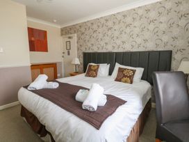 A bedroom with a bed and bedside lamp at 9 The Esplanade