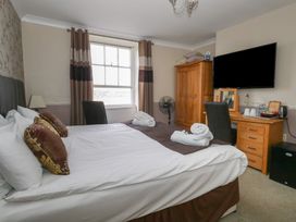 A bedroom with a bed and a television at 9 The Esplanade