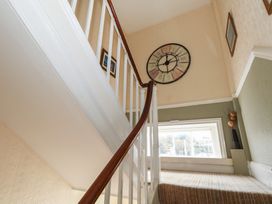 A staircase with a clock on the wall at 9 The Esplanade