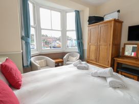 A bedroom with a bed and furniture at 9 The Esplanade 