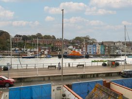 A waterfront scene with boats and buildings at 9 The Esplanade