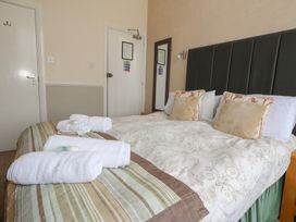 A bedroom with a bed and towels at 9 The Esplanade in 