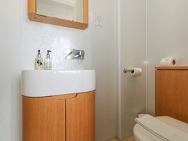 A bathroom with a sink and a mirror at 9 The Esplanade 