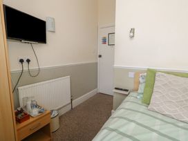 A bedroom with a bed and television at 9 The Esplanade