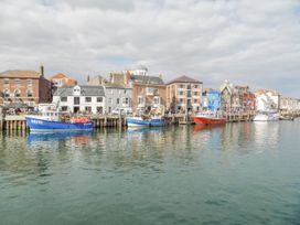 A harbor with boats and buildings at 9 The Esplanade