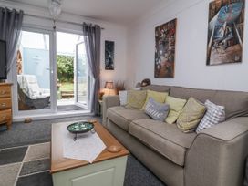 A living room with a sofa and coffee table at Ocean Cottage in Bude