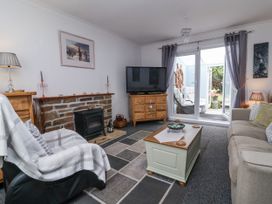A living room with a television and fireplace at Ocean Cottage in Bude