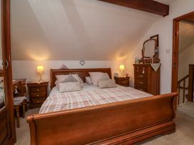 A bedroom with a bed and nightstand at Ocean Cottage Bude