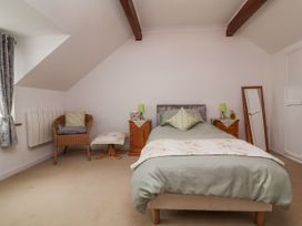 A bedroom with a bed and bedside tables at Ocean Cottage in Bude