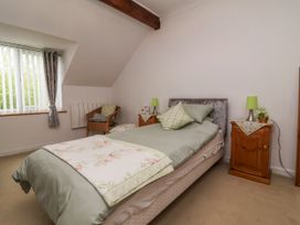 A bedroom with a bed and nightstands at Ocean Cottage in Bude