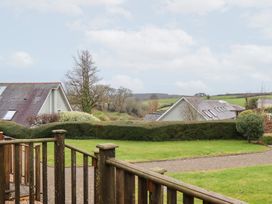 View of houses and trees from a patio at 3 Keepers Cottage