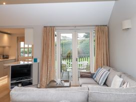A living room with a sofa and a coffee table at 3 Keepers Cottage