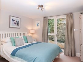 A bedroom with a bed and bedside table at 3 Keepers Cottage
