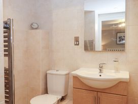 A bathroom with a toilet and wash basin at 3 Keepers Cottage