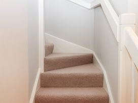 A staircase with carpeted steps at 3 Keepers Cottage