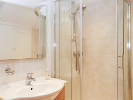 A bathroom with a shower and sink at 3 Keepers Cottage