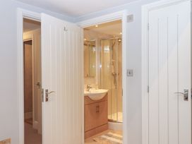 A bathroom with a sink and shower at 3 Keepers Cottage