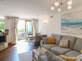 A living room with a sofa and dining table at 3 Keepers Cottage, Hillfield Village near Dartmouth