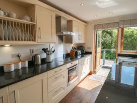 A kitchen with cabinets and appliances at 3 Keepers Cottage, Hillfield Village near Dartmouth