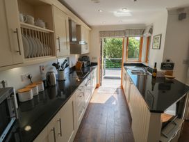 A kitchen with cabinets and appliances at 3 Keepers Cottage, Hillfield Village near Dartmouth