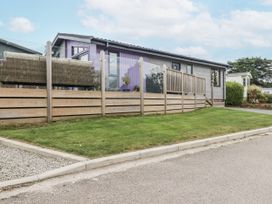 A house with decking and fence at Minack Lodge in Redruth