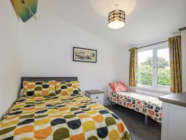 A bedroom with a double bed and a single bed at Minack Lodge Redruth