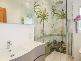 A bathroom with a shower and sink at Minack Lodge in Redruth