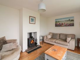 A living room with a fireplace and sofas at Tapps Lodge in Plymouth
