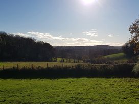 A landscape view with trees and hills at Tapps Lodge, Brixton near Yealmpton, South Devon