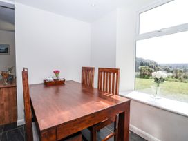A dining room with a table and chairs at Tapps Lodge Brixton near Yealmpton, South Devon